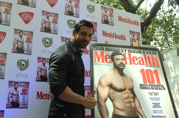 Handsome John Abraham unveils a magazine cover featuring himself