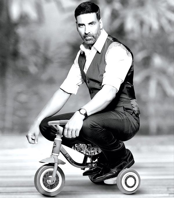 Akshay Kumar poses with a kid cycle in Dabboo Ratnani's Calendar for 2015
