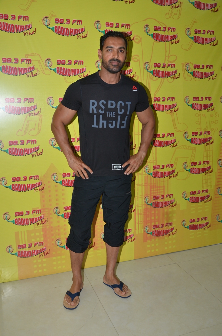 John Abraham poses for the shutterbugs at a radio station