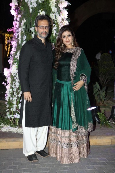 Raveena Tandon poses with her husband at Manish Malhotra's niece Riddhi's sangeet function
