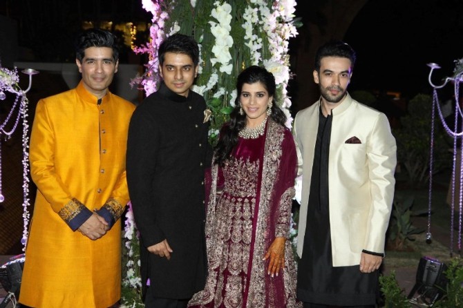 Manish Malhotra and Punit Malhotra pose with Riddhi and her husband at sangeet function