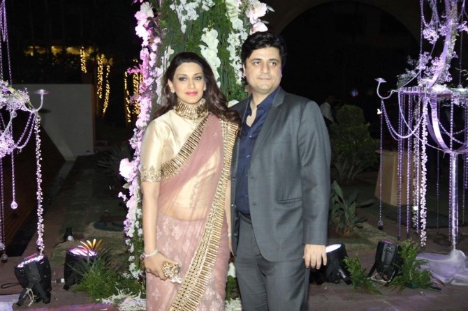 Sonali Bendre poses with her husband at Manish Malhotra's niece Riddhi's sangeet function