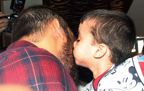 A small fan of Salman Khan kissing him at a jewellery store launch