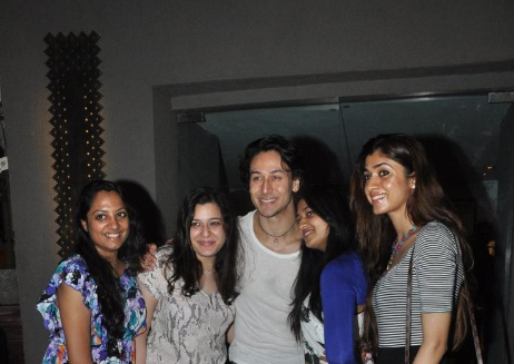 Tiger Shroff poses with fans at a restaurant